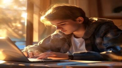 Person studying IT certification at laptop in clean home office